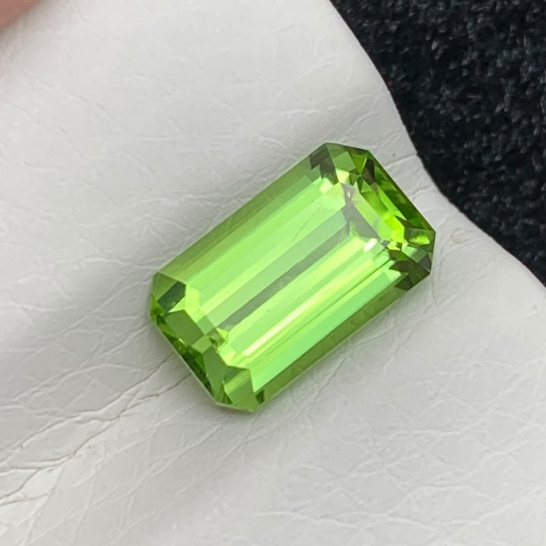 A rectangular emerald-cut green peridot gemstone